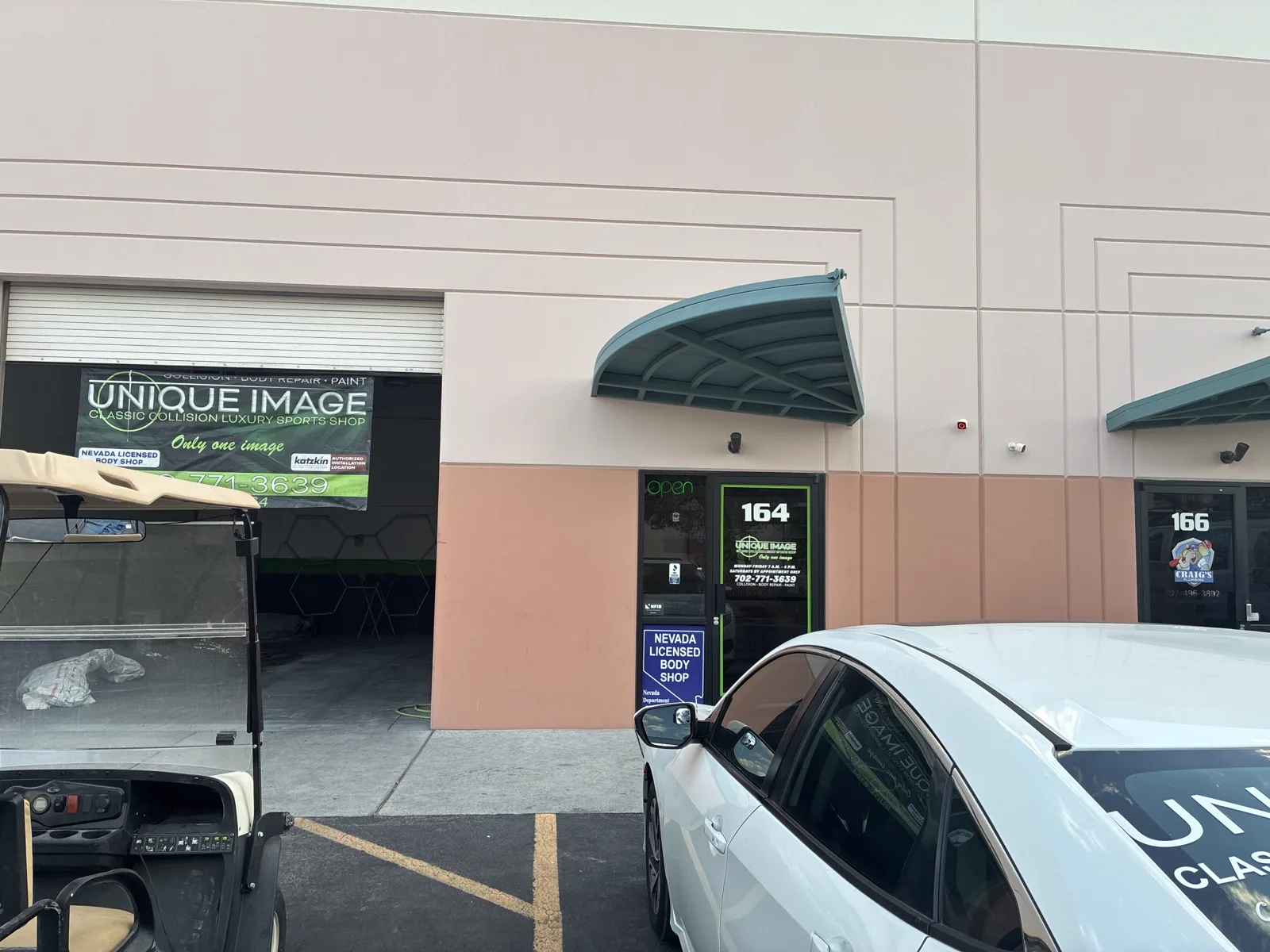 The Unique Image entrance at Suite 164 with the open sign and posted shop hours